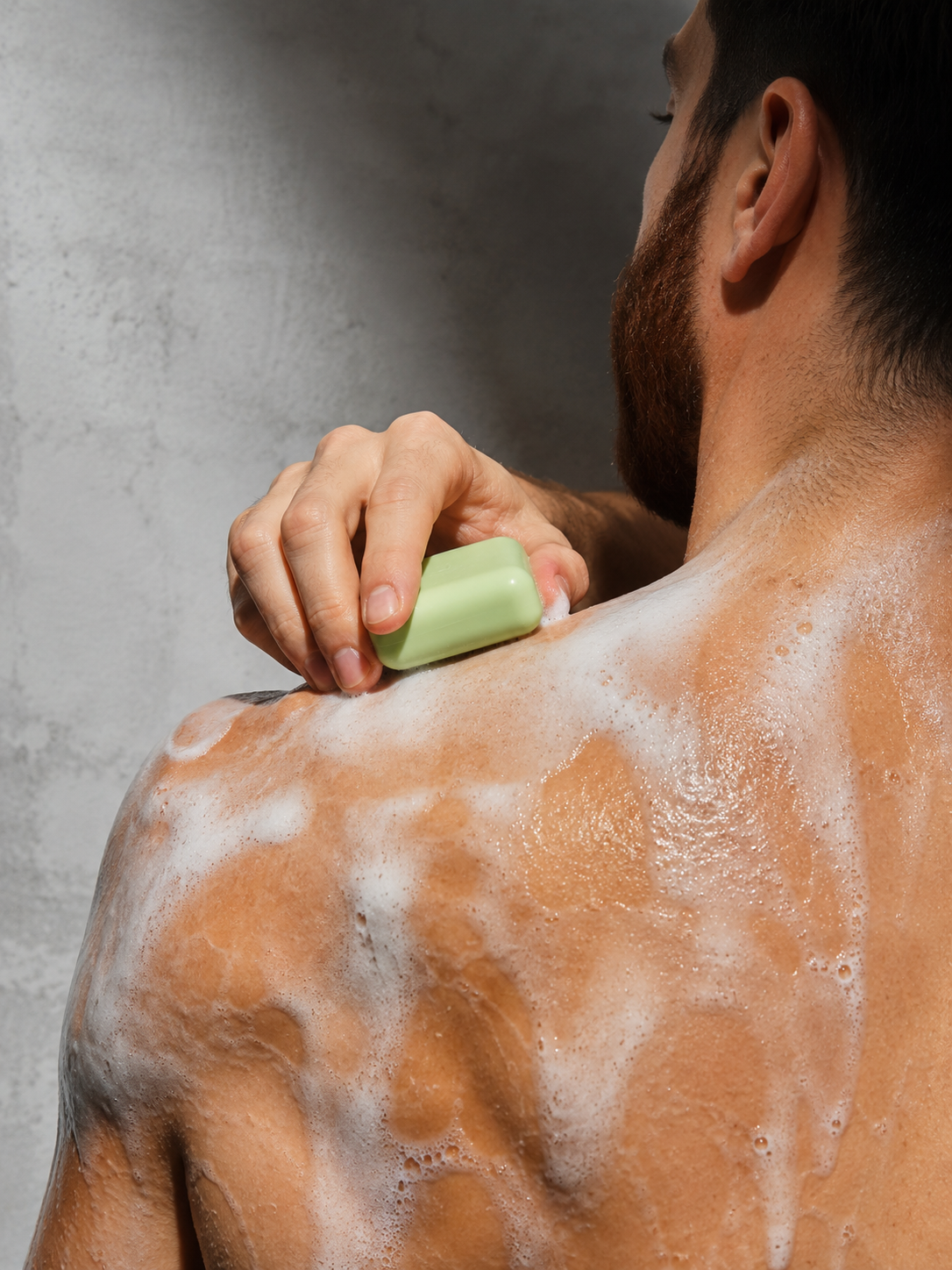 Man using KELEB'S body bar in shower